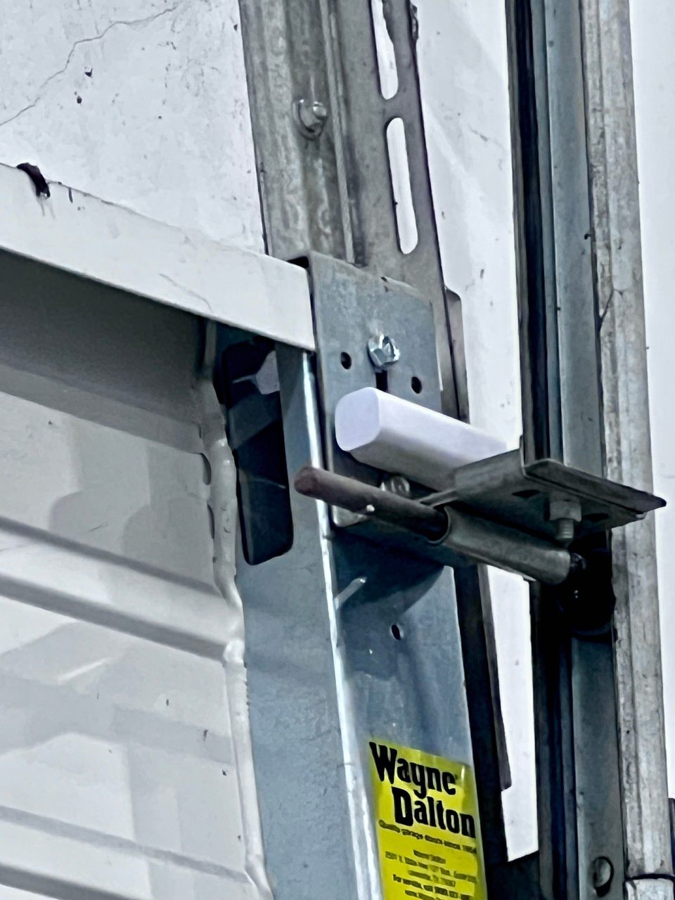 Contact sensor and slide bolt mounted on a dock door track