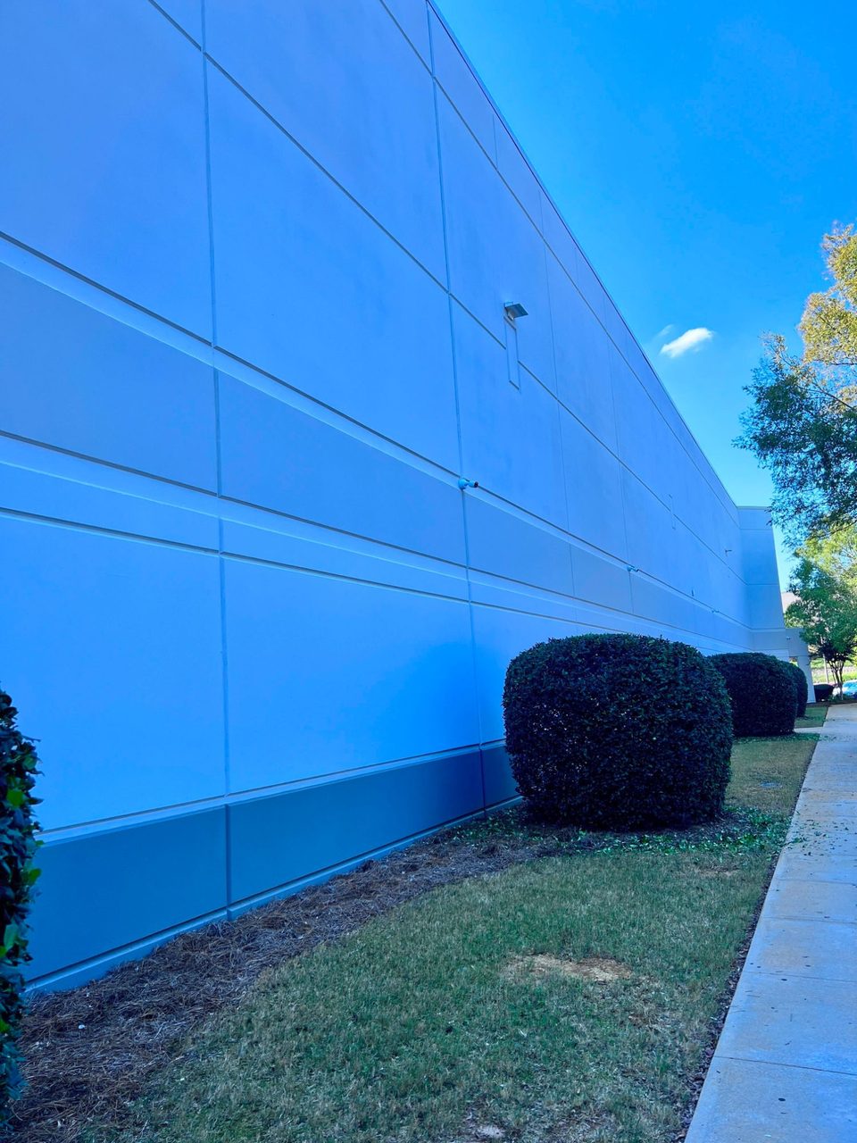Security cameras mounted along the exterior wall of a ZonPrep warehouse